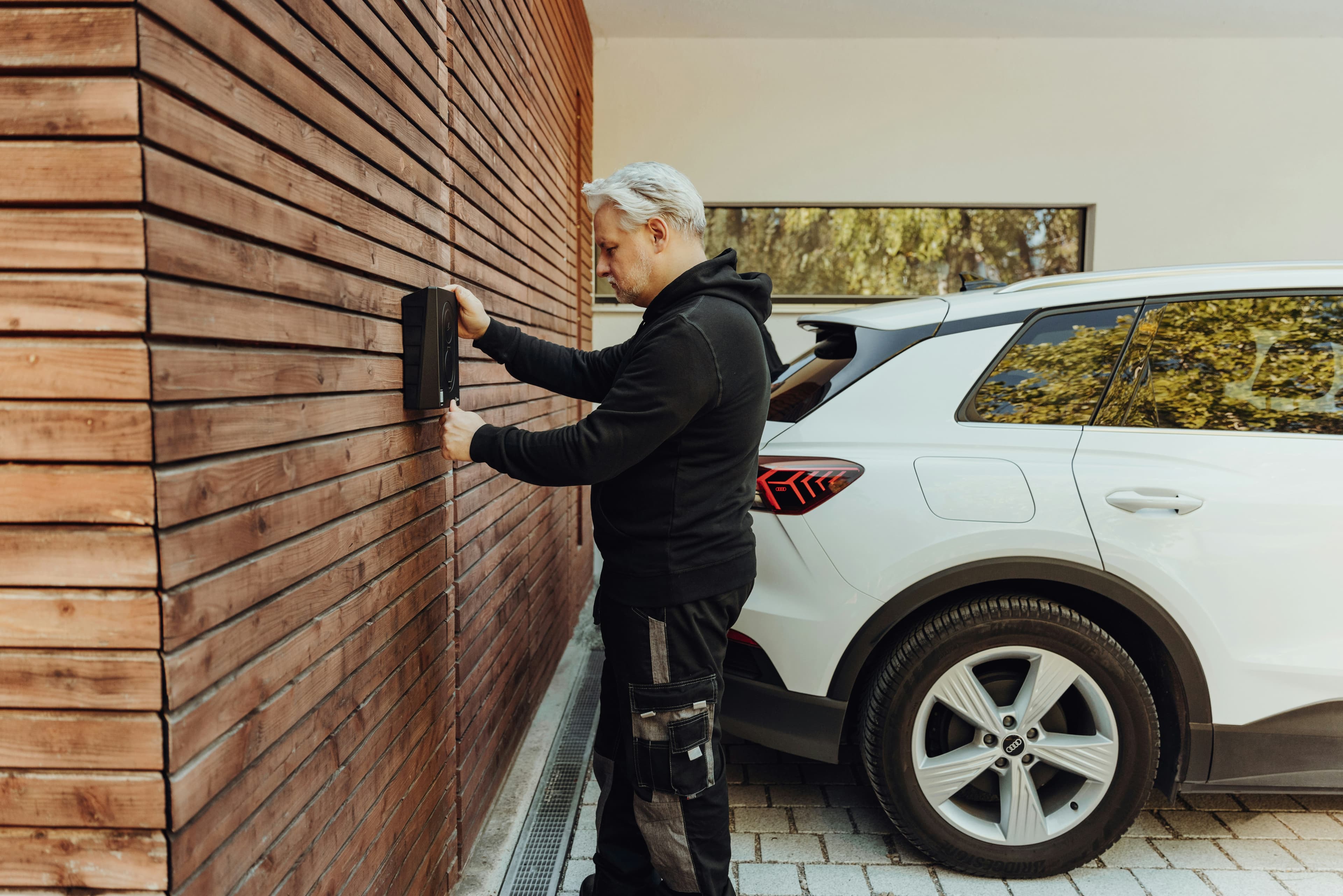 Professional electrician installing a home EV charging station